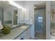 Bathroom with walk-in shower and tiled walls at 16271 N Island Ct, Boca Grande, FL 33921