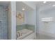 Bathroom with soaking tub and shell art at 16271 N Island Ct, Boca Grande, FL 33921