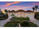 Two story home with attached garage and landscaping at 16271 N Island Ct, Boca Grande, FL 33921