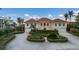 Two-story house with orange tile roof, three-car garage, and manicured landscaping at 16271 N Island Ct, Boca Grande, FL 33921