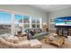 Bright living room with ocean views, comfy seating, and large TV at 16271 N Island Ct, Boca Grande, FL 33921