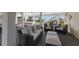Lower lanai with seating area and access to backyard at 16271 N Island Ct, Boca Grande, FL 33921