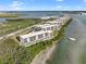 Aerial view of waterfront condos with boat slips and lush landscaping at 1751 Beach Rd # 403, Englewood, FL 34223
