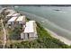 Stunning aerial of waterfront condos with lush landscaping and a boat at 1751 Beach Rd # 403, Englewood, FL 34223