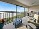 Relaxing balcony with waterfront views, comfy seating and a table at 1751 Beach Rd # 403, Englewood, FL 34223