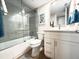 Modern bathroom with gray tile, a glass shower, and white vanity at 1751 Beach Rd # 403, Englewood, FL 34223