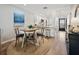Dining area features a white round table with four chairs and a view into the kitchen at 1751 Beach Rd # 403, Englewood, FL 34223