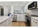 Open concept kitchen with stainless steel appliances and white cabinets at 1751 Beach Rd # 403, Englewood, FL 34223