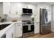 Updated kitchen featuring stainless steel appliances and white shaker cabinets at 1751 Beach Rd # 403, Englewood, FL 34223