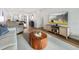 Living area features a comfy sofa, round coffee table, and hardwood floors at 1751 Beach Rd # 403, Englewood, FL 34223