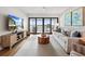 Living room boasts a large TV, comfy sofa, and stunning water views at 1751 Beach Rd # 403, Englewood, FL 34223