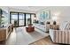Living room with light sofa, wood coffee table, and sliding doors to balcony at 1751 Beach Rd # 403, Englewood, FL 34223