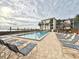 Relaxing community pool area with plenty of lounge chairs at 1751 Beach Rd # 403, Englewood, FL 34223