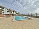 Community pool with lounge chairs, offering waterfront views at 1751 Beach Rd # 403, Englewood, FL 34223