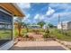 Private backyard with patio, fire pit, and lush landscaping at 1780 Morning Dove Ln, Englewood, FL 34224