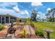Landscaped backyard with patio, fire pit and bird bath at 1780 Morning Dove Ln, Englewood, FL 34224
