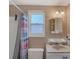Small bathroom with shower, window and white vanity at 1780 Morning Dove Ln, Englewood, FL 34224