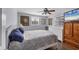Bedroom with white dresser, ceiling fan, and blue and beige comforter at 1780 Morning Dove Ln, Englewood, FL 34224
