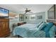 Bedroom with wood dresser, ceiling fan and a blue chevron comforter at 1780 Morning Dove Ln, Englewood, FL 34224