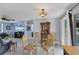 Bright dining area with glass table and four chairs, adjacent to living room at 1780 Morning Dove Ln, Englewood, FL 34224