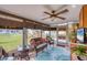 Relaxing Florida room with wicker furniture and view to backyard at 1780 Morning Dove Ln, Englewood, FL 34224