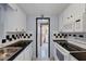 Efficient kitchen with white appliances and checkerboard backsplash at 1780 Morning Dove Ln, Englewood, FL 34224