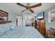 Main bedroom with large bed, wood dresser and mirrored closet doors at 1780 Morning Dove Ln, Englewood, FL 34224