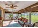 Relaxing sunroom with wicker furniture and view of backyard at 1780 Morning Dove Ln, Englewood, FL 34224