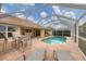 Inviting pool area with patio furniture and screened enclosure at 193 Tournament Rd, Rotonda West, FL 33947