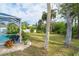 Spacious backyard with lush landscaping and mature trees at 217 Wayne Rd, Rotonda West, FL 33947