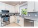 Bright kitchen features white cabinets and gray backsplash at 217 Wayne Rd, Rotonda West, FL 33947