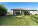 Spacious backyard with covered patio and lush landscaping at 226 Rotonda N Blvd, Rotonda West, FL 33947