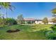 Large backyard with grassy lawn and partial view of home at 226 Rotonda N Blvd, Rotonda West, FL 33947