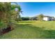 Expansive backyard, mostly lawn, with tropical plants at 226 Rotonda N Blvd, Rotonda West, FL 33947