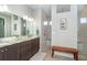 Elegant bathroom with double vanity, large shower, and bench at 226 Rotonda N Blvd, Rotonda West, FL 33947