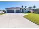 Two-car garage and nicely landscaped lawn at 226 Rotonda N Blvd, Rotonda West, FL 33947