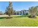 Landscaped front yard with mature trees and curb appeal at 226 Rotonda N Blvd, Rotonda West, FL 33947