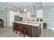 Island kitchen with granite countertops and white cabinets at 226 Rotonda N Blvd, Rotonda West, FL 33947