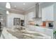 Modern kitchen features white cabinets, granite countertops, and a stainless steel range hood at 226 Rotonda N Blvd, Rotonda West, FL 33947