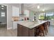 Spacious kitchen with an island, granite countertops, and white shaker cabinets at 226 Rotonda N Blvd, Rotonda West, FL 33947