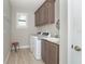 Convenient laundry room with washer, dryer, and additional storage at 226 Rotonda N Blvd, Rotonda West, FL 33947