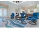 Relaxing living area with blue seating and a large rug at 226 Rotonda N Blvd, Rotonda West, FL 33947