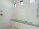 Walk-in shower with granite seat and pebble floor at 226 Rotonda N Blvd, Rotonda West, FL 33947