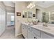 Double vanity bathroom with access to bedroom at 24028 Canterwood Way, Venice, FL 34293