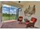 Relaxing screened patio with wicker furniture at 24028 Canterwood Way, Venice, FL 34293