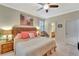 King-size bedroom with ceiling fan and en-suite bathroom at 2482 Arugula Dr, North Port, FL 34289