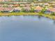 Community overview showcasing lakefront homes and lush landscape at 26837 Weiskopf Dr, Englewood, FL 34223
