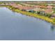 Aerial view of a luxury home community with lakefront properties at 26837 Weiskopf Dr, Englewood, FL 34223