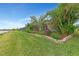 Landscaped backyard with lush greenery and a relaxing view at 26837 Weiskopf Dr, Englewood, FL 34223