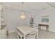 Bright dining room featuring white table and chandelier at 26837 Weiskopf Dr, Englewood, FL 34223